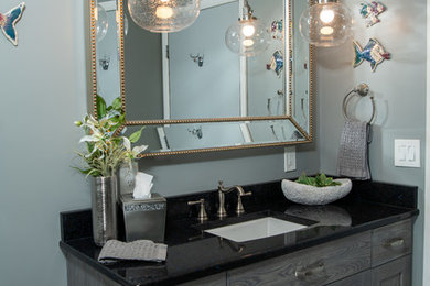 Example of a small beach style 3/4 blue tile and glass tile porcelain tile and gray floor bathroom design in Other with flat-panel cabinets, gray cabinets, gray walls, quartz countertops and black countertops