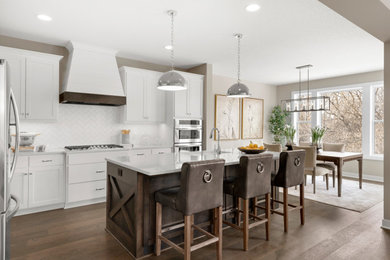 Transitional l-shaped medium tone wood floor eat-in kitchen photo in Minneapolis with shaker cabinets, white cabinets, quartzite countertops, white backsplash, stainless steel appliances, an island and white countertops