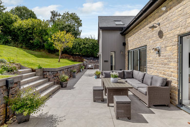 Photo of a medium sized country back patio in Devon with no cover.