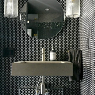 Trendy black tile and gray tile powder room photo in Orange County with a wall-mount sink