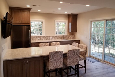 Transitional single-wall vinyl floor home bar photo in Other with an undermount sink, flat-panel cabinets, brown cabinets, quartz countertops and beige countertops
