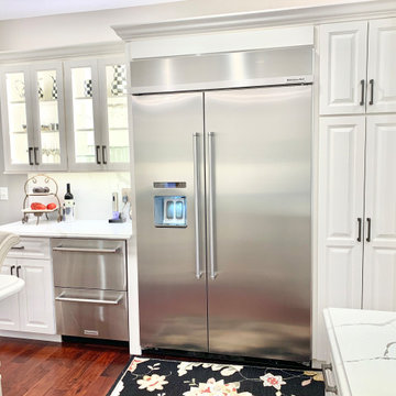 Ivory White Kitchen With Marble Look Quartz Counters and Splash