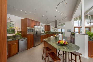 Example of a large transitional l-shaped porcelain tile eat-in kitchen design in Hawaii with an undermount sink, shaker cabinets, medium tone wood cabinets, granite countertops, green backsplash, stone slab backsplash, stainless steel appliances and an island