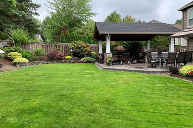 Inspiration for a mid-sized timeless backyard concrete paver patio remodel in Portland with a gazebo