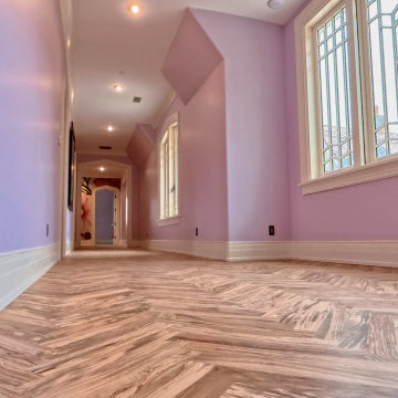 Custom Luxury Hallway with Vaulted Ceilings and Herringbone Flooring