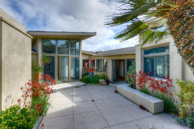 Entryway - mid-sized modern concrete floor entryway idea in San Diego with a glass front door