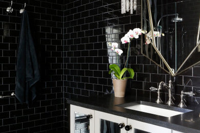 Example of a mid-sized transitional kids' black tile and subway tile porcelain tile and black floor bathroom design in Nashville with glass-front cabinets, white cabinets, a one-piece toilet, black walls, an undermount sink, quartz countertops and black countertops