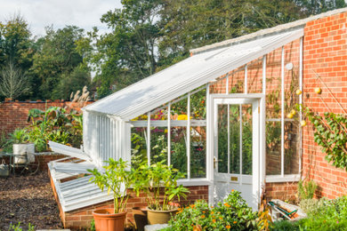 Medium sized victorian attached greenhouse in Other.