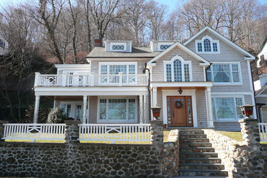 Large elegant beige three-story wood exterior home photo in New York with a shingle roof
