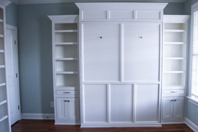 Example of a mid-sized classic medium tone wood floor home office design in Raleigh with green walls