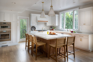 Elegant kitchen photo in New York with an island