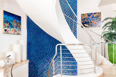 Example of a large trendy tile spiral metal railing staircase design in San Diego with tile risers