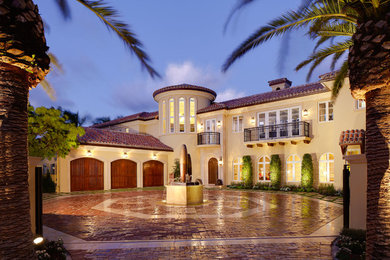 Tuscan yellow two-story exterior home photo in Miami