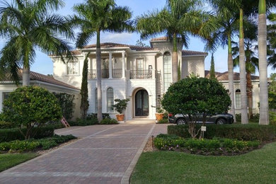 Inspiration for a large traditional two-storey beige exterior in Miami with mixed siding and a hip roof.