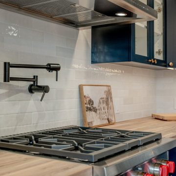Matte Black Pot Filler and Wolf Range with Butcher Block Countertops