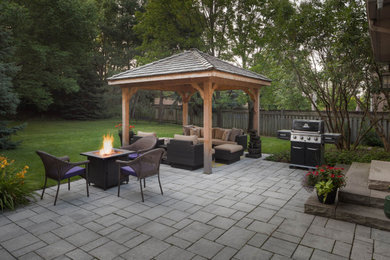 Mid-sized contemporary backyard patio in Toronto with concrete pavers.