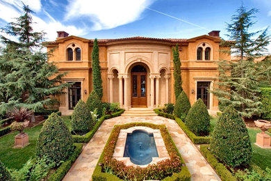 Example of a tuscan two-story exterior home design in Los Angeles