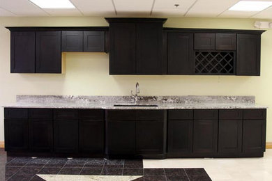 Inspiration for a mid-sized single-wall kitchen pantry in Detroit with an undermount sink, recessed-panel cabinets, dark wood cabinets, granite benchtops, stainless steel appliances, marble floors and no island.