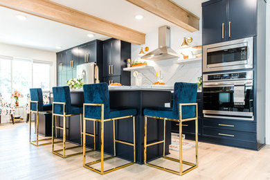Example of a mid-sized minimalist single-wall vinyl floor and brown floor eat-in kitchen design in Minneapolis with an undermount sink, shaker cabinets, blue cabinets, quartz countertops, white backsplash, quartz backsplash, stainless steel appliances, an island and white countertops