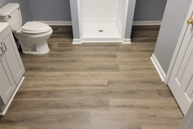 Example of a small classic laminate floor and gray floor toilet room design in Atlanta