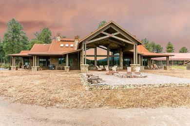 Large craftsman brown one-story mixed siding exterior home idea in Other