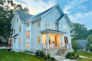Example of a large beige four-story concrete fiberboard and clapboard exterior home design in DC Metro with a mixed material roof and a gray roof