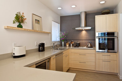 Mid-sized minimalist u-shaped linoleum floor eat-in kitchen photo in San Luis Obispo with an undermount sink, flat-panel cabinets, light wood cabinets, quartz countertops, gray backsplash, ceramic backsplash and stainless steel appliances