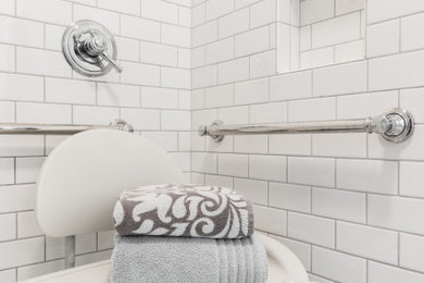 Example of a mid-sized transitional white tile and ceramic tile ceramic tile, gray floor and single-sink bathroom design in Dallas with raised-panel cabinets, white cabinets, a two-piece toilet, gray walls, an integrated sink, solid surface countertops and white countertops