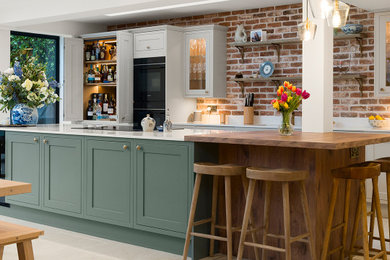 This is an example of a large classic kitchen in Surrey.