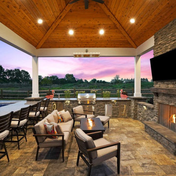 Pavilion with outdoor kitchen, gas fireplace and swim up bar.