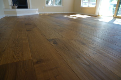 Elegant medium tone wood floor and brown floor family room photo in Denver