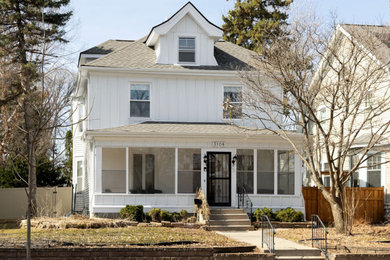 Inspiration for a large timeless white three-story wood house exterior remodel in Minneapolis with a shingle roof and a gray roof