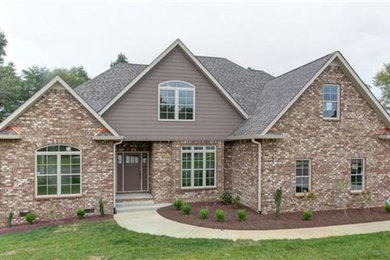 Example of a trendy brown two-story brick exterior home design in Nashville