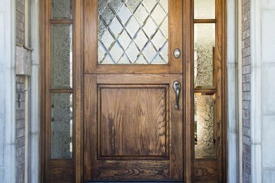 Entryway - mid-sized traditional concrete floor entryway idea in Orange County with beige walls and a medium wood front door