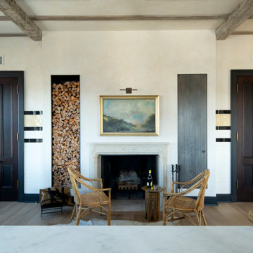 Hand Hewn Timber Ceiling Beams in a French Country Dining Room with Fireplace