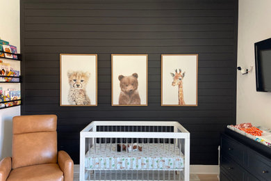 Inspiration for a mid-sized contemporary gender-neutral medium tone wood floor, brown floor and shiplap wall nursery remodel in Atlanta with black walls