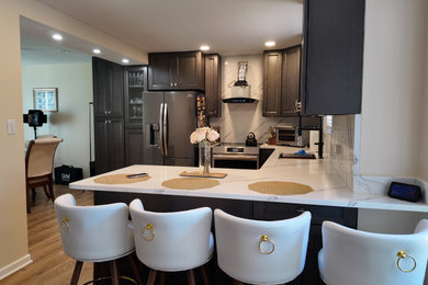 Inspiration for a mid-sized contemporary u-shaped eat-in kitchen remodel in Richmond with an undermount sink, shaker cabinets, dark wood cabinets, quartz countertops, white backsplash, quartz backsplash and white countertops