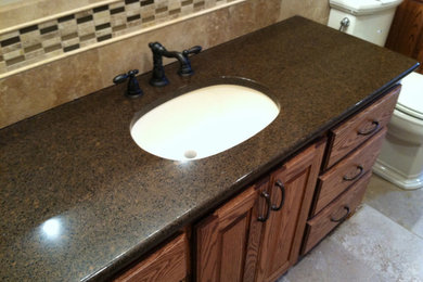 Example of a classic bathroom design in Other with a drop-in sink, beaded inset cabinets and medium tone wood cabinets