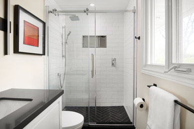 Example of a small minimalist white tile and ceramic tile ceramic tile, black floor and single-sink bathroom design in Ottawa with white cabinets, white walls, an integrated sink, quartzite countertops and black countertops