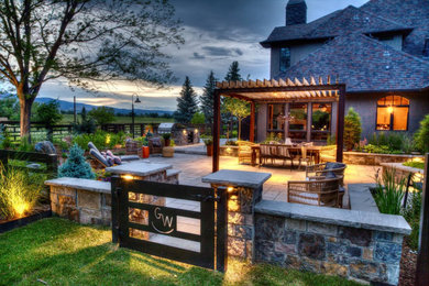 Inspiration for a large farmhouse backyard stone gate in Denver.