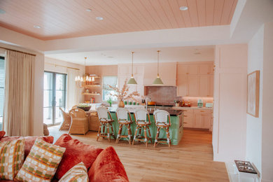 Open concept kitchen - large eclectic l-shaped light wood floor and shiplap ceiling open concept kitchen idea in Los Angeles with pink cabinets, granite countertops, pink backsplash, ceramic backsplash, paneled appliances and an island
