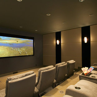 Cette image montre une salle de cinéma design avec un mur vert, moquette et un écran de projection.