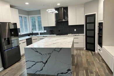 Inspiration for a mid-sized contemporary kitchen pantry remodel in DC Metro with flat-panel cabinets, white cabinets, granite countertops and an island
