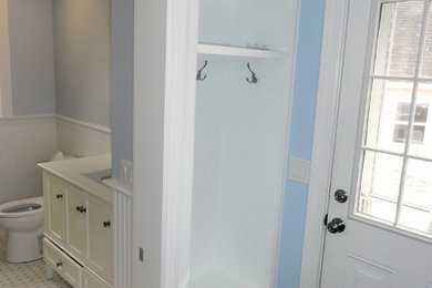 Mudroom - small coastal light wood floor mudroom idea in Portland Maine with blue walls