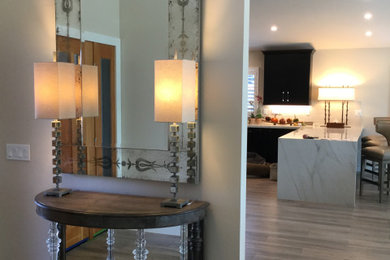 Foyer - large modern medium tone wood floor and gray floor foyer idea in San Francisco with white walls