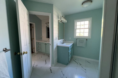 Example of a large trendy master white tile and ceramic tile vinyl floor, white floor, double-sink and shiplap wall bathroom design in Detroit with shaker cabinets, turquoise cabinets, a two-piece toilet, blue walls, a drop-in sink, laminate countertops, white countertops and a built-in vanity