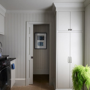 Laundry Room with Custom Cabinets and Limestone Flooring