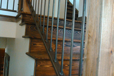 Example of a mid-sized mountain style wooden straight mixed material railing staircase design in Other with wooden risers