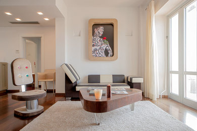 Photo of a large contemporary living room in Florence with white walls and medium hardwood floors.