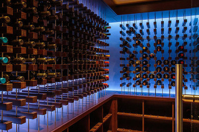 Photo of a mid-sized contemporary wine cellar in Boston with storage racks.
